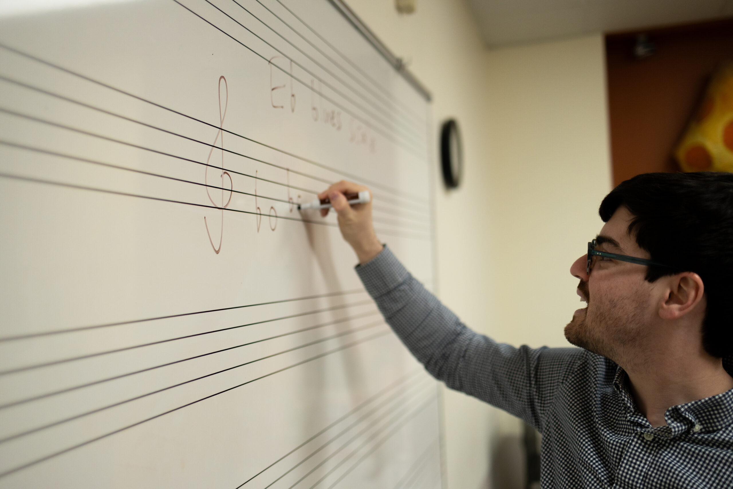 CMCB instructor writing music on a white board