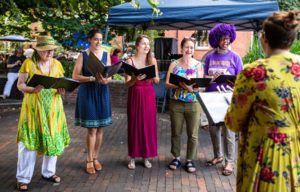 A group of people singing outside