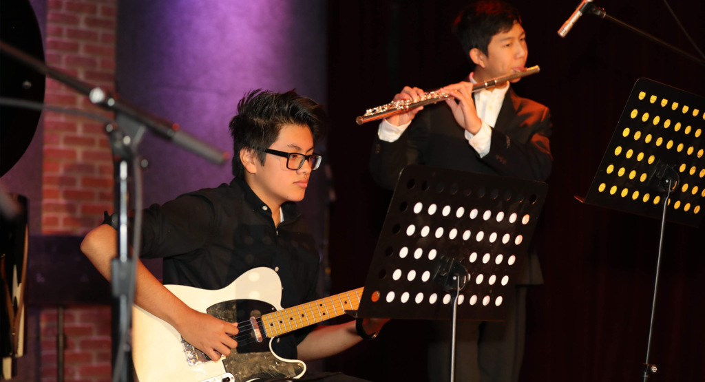 Two students perform on stage during the John Kleshinski Fundraiser in 2019